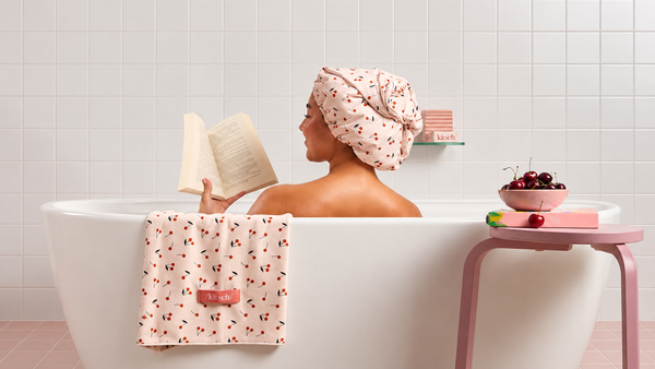 Woman using Cherry Print Satin Lined Flexi Shower Cap by KITSCH