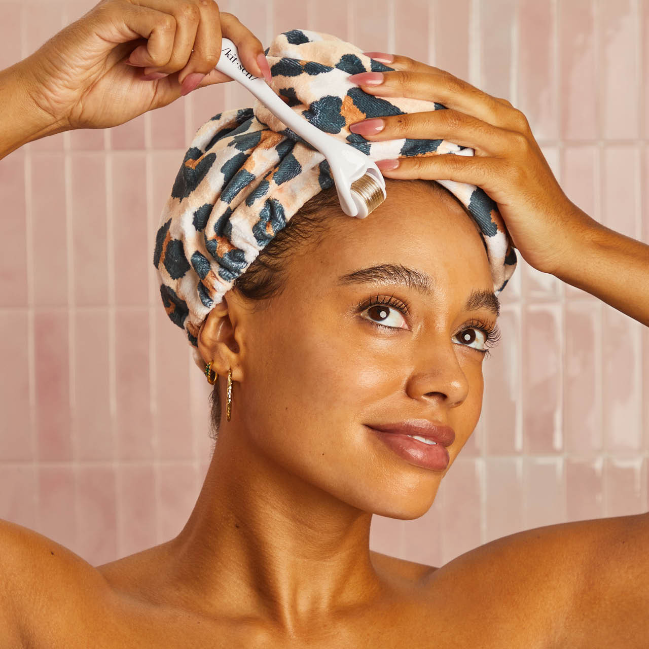 Model wrapping Kitsch Leopard Print Microfiber Hair Towel around wet hair