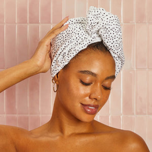 Model wrapping Kitsch Micro Dot Microfiber Hair Towel around wet hair