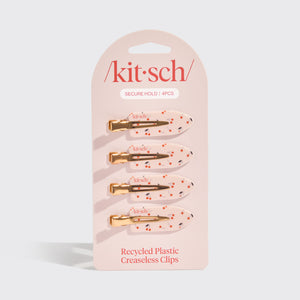 Kitsch Cherry Print Creaseless Clips 4pc Set displayed in retail packaging on a gray background.