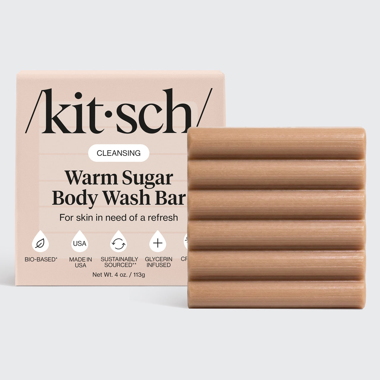 Kitsch Cleansing Warm Sugar Body Wash Bar with ridged bar and packaging on a light gray background