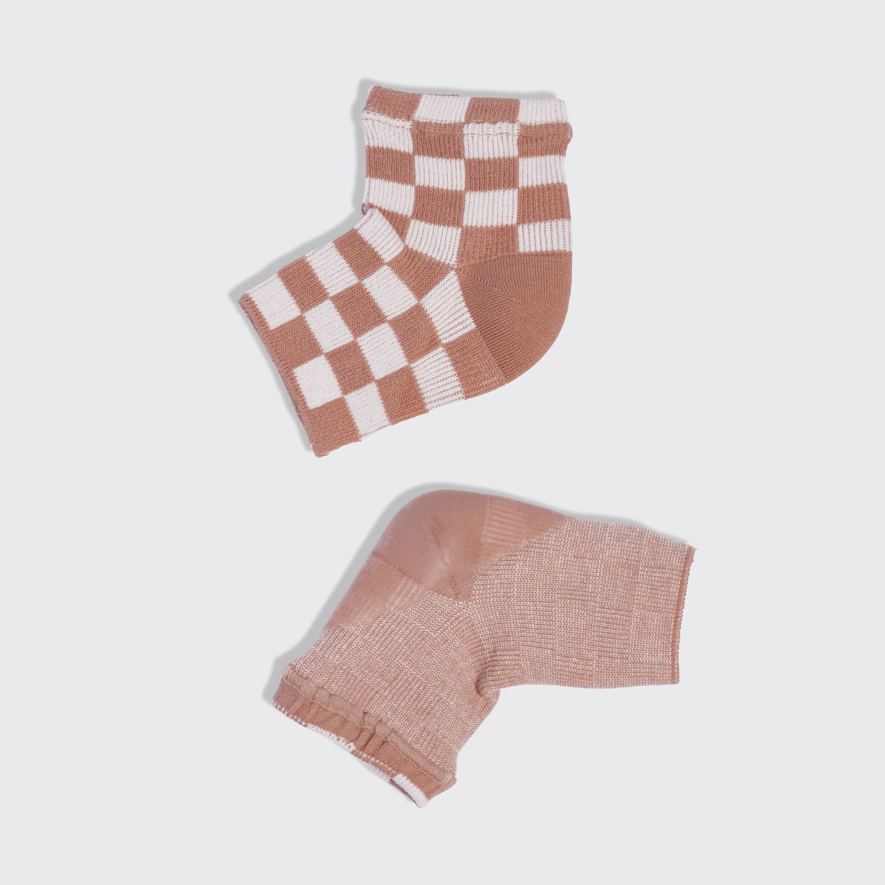 Kitsch Terracotta Checker Moisturizing Heel Socks showing the checked exterior and gel-lined moisturizing heel interior.