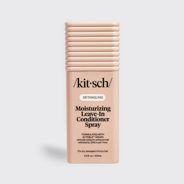 Kitsch Moisturizing Leave-In Conditioner Spray in blush packaging for dry, damaged, and frizzy hair, formulated with Actimilk™ Argan.