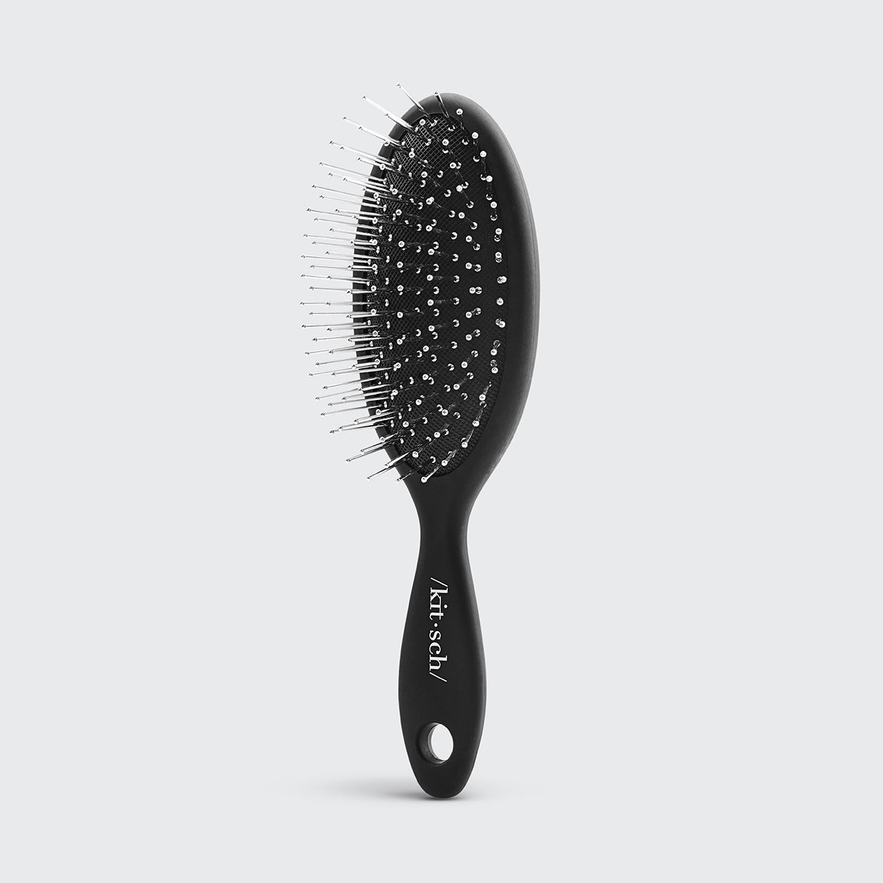Mini spazzola per capelli da viaggio con setole metalliche create consapevolmente