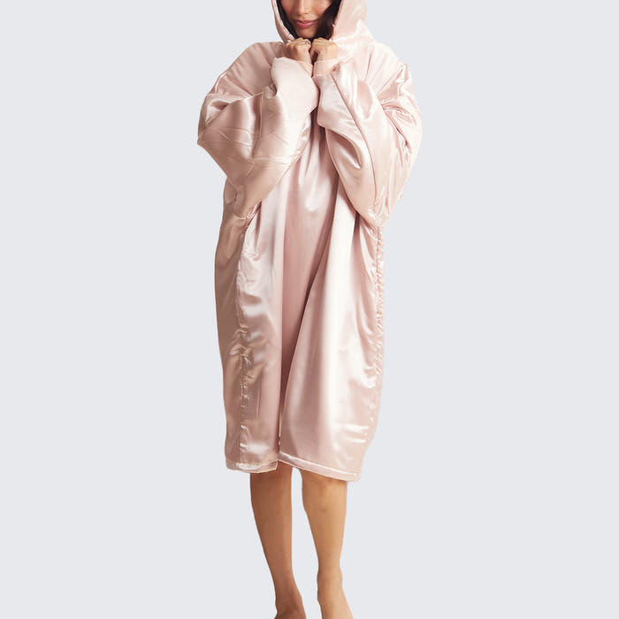 Model wearing the Kitsch Glazey in Blush, a satin hooded robe designed for cozy comfort and overnight hair protection.